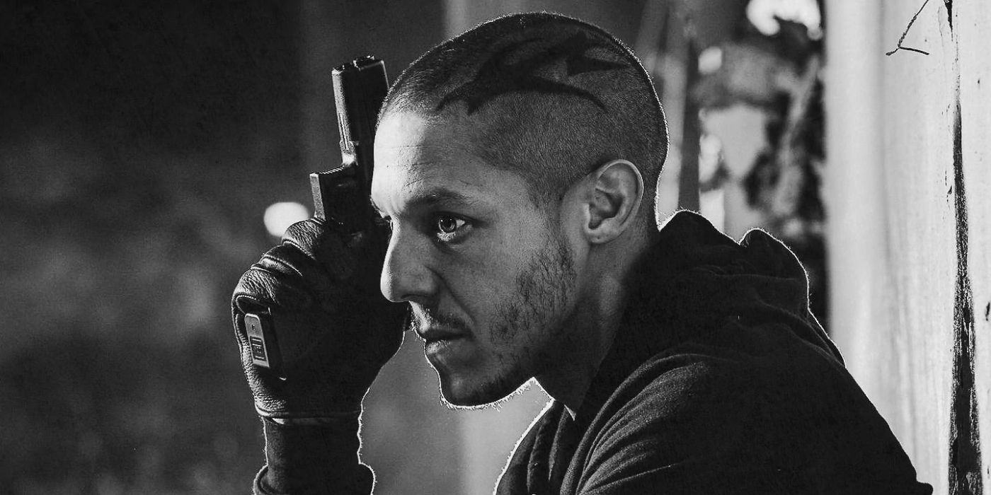 A black and white photo of Juice holding a gun in Sons of Anarchy