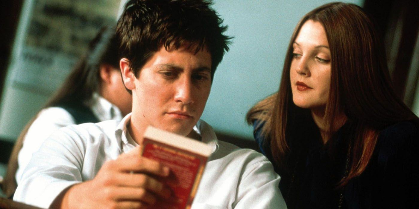 A young woman looks at Donnie Darko as he holds a book