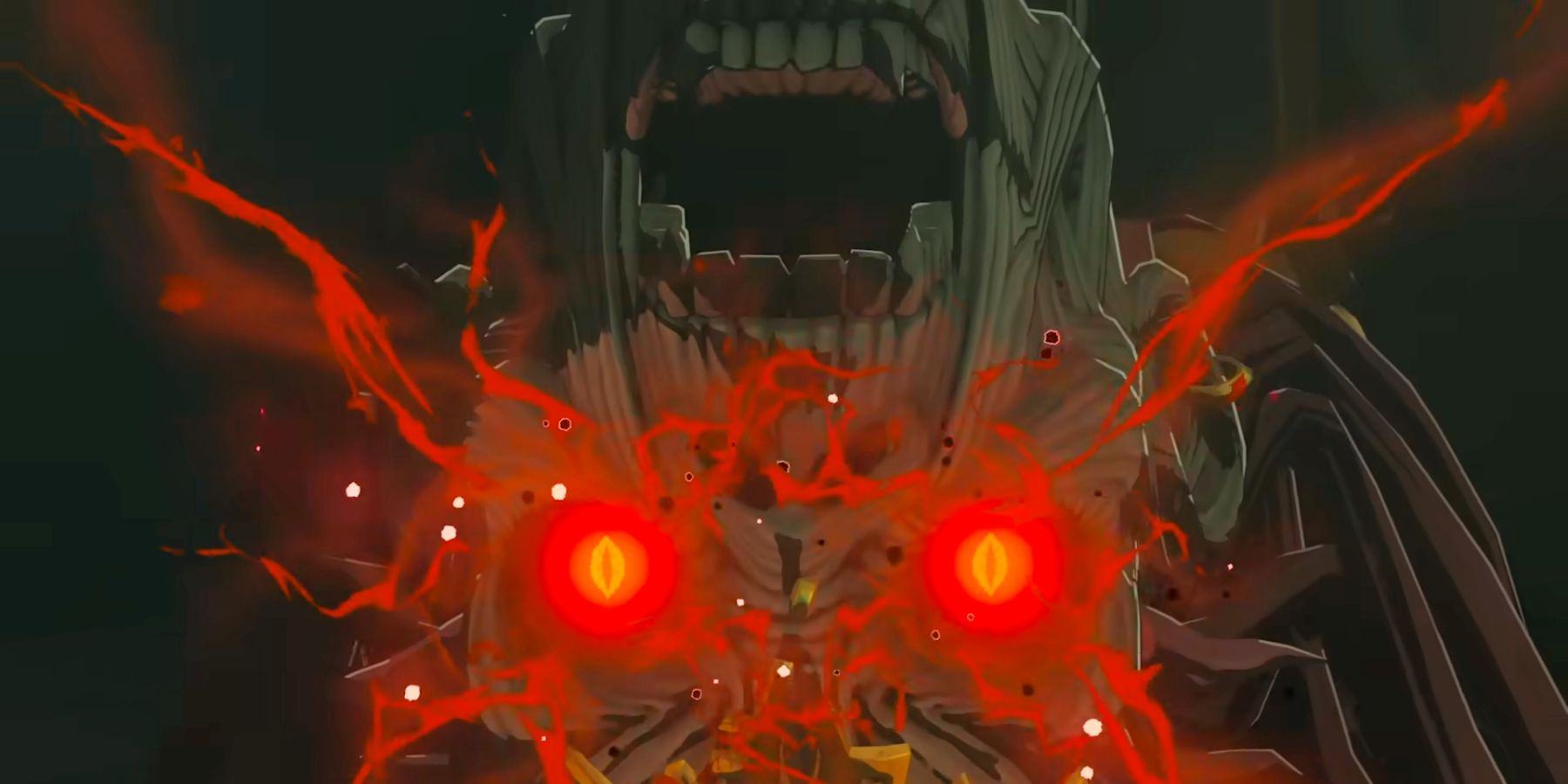 A close-up of Ganondorf's face upside down in Tears of the Kingdom, bright red eyes glowing and giving off some sort of energy.