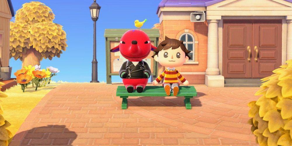 A red elephant in a leather jacket sits on a bench with the player.