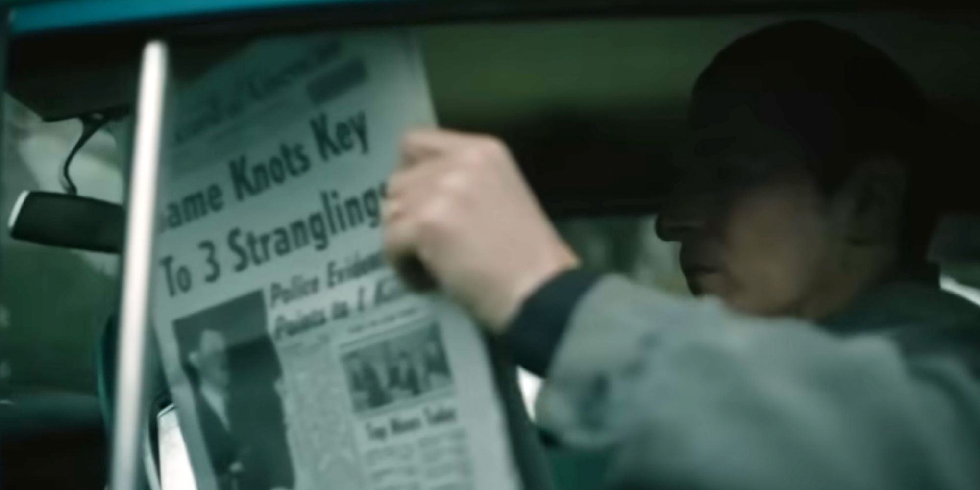 Boston strangler holding a newspaper