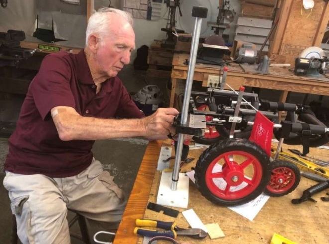 A retired veterinarian builds wheelchairs for poor, disabled dogs, giving them a chance to move around