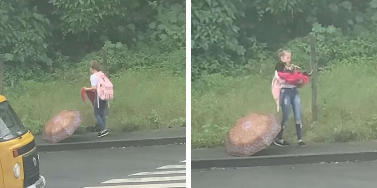 A little girl is seen helping and rescuing a cute puppy that got drenched in the rain