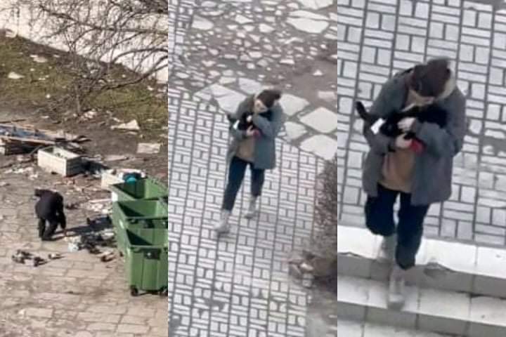 A woman holds and comforts a scared cat as air raid sirens sound in Ukraine