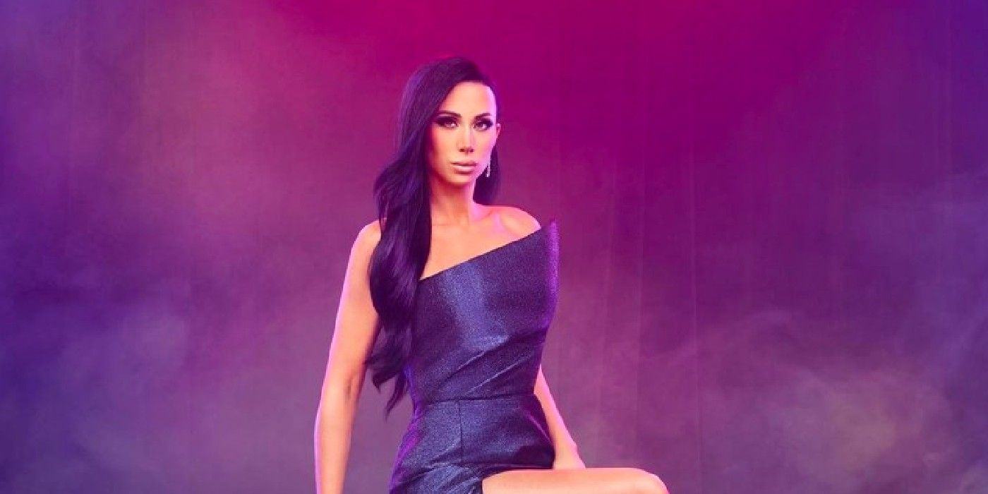 RHONJ's Rachel Fuda wearing purple, posing in front of purple background