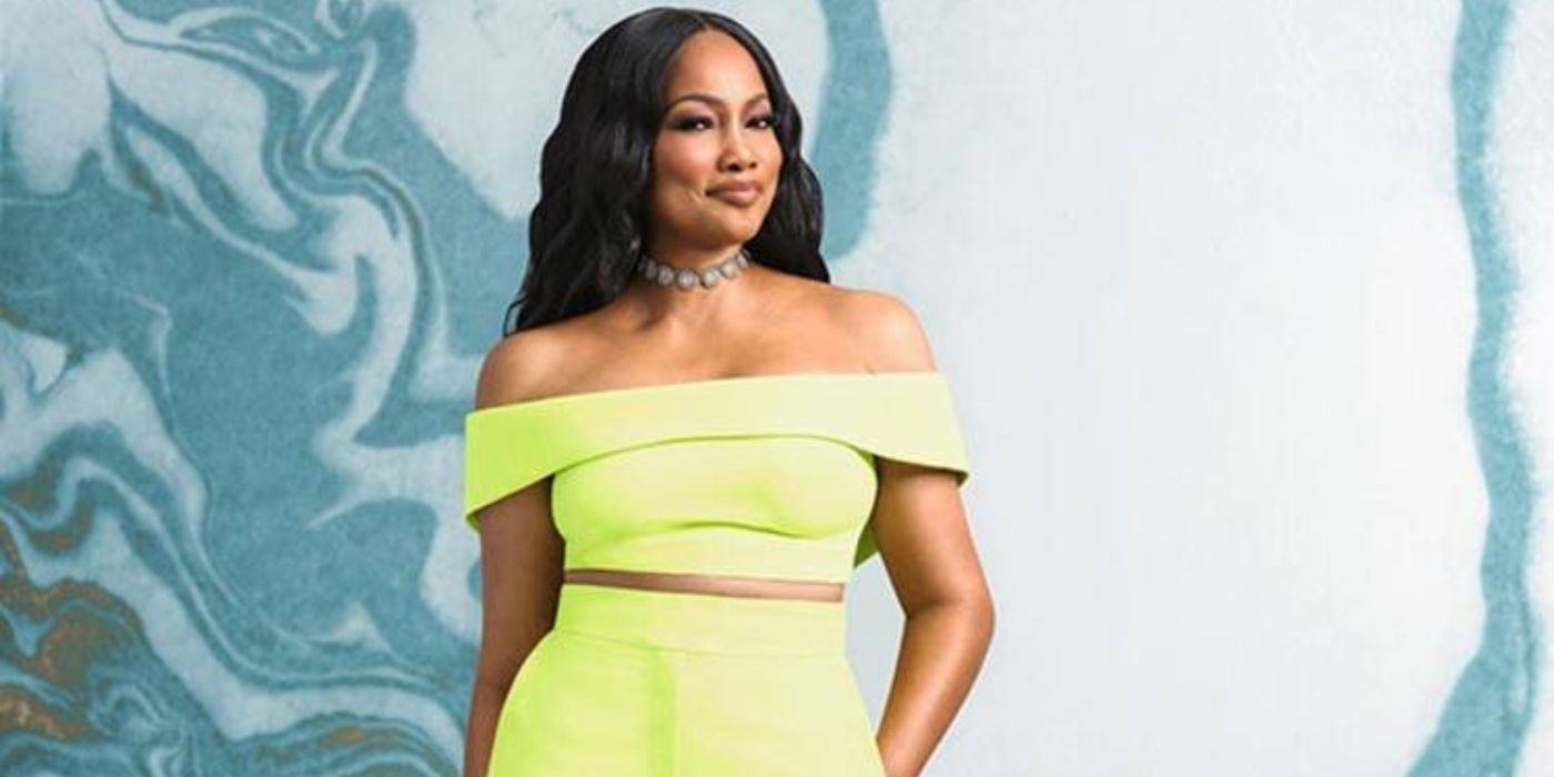 Garcelle Beauvais on RHOBH posing in yellow dress blue background