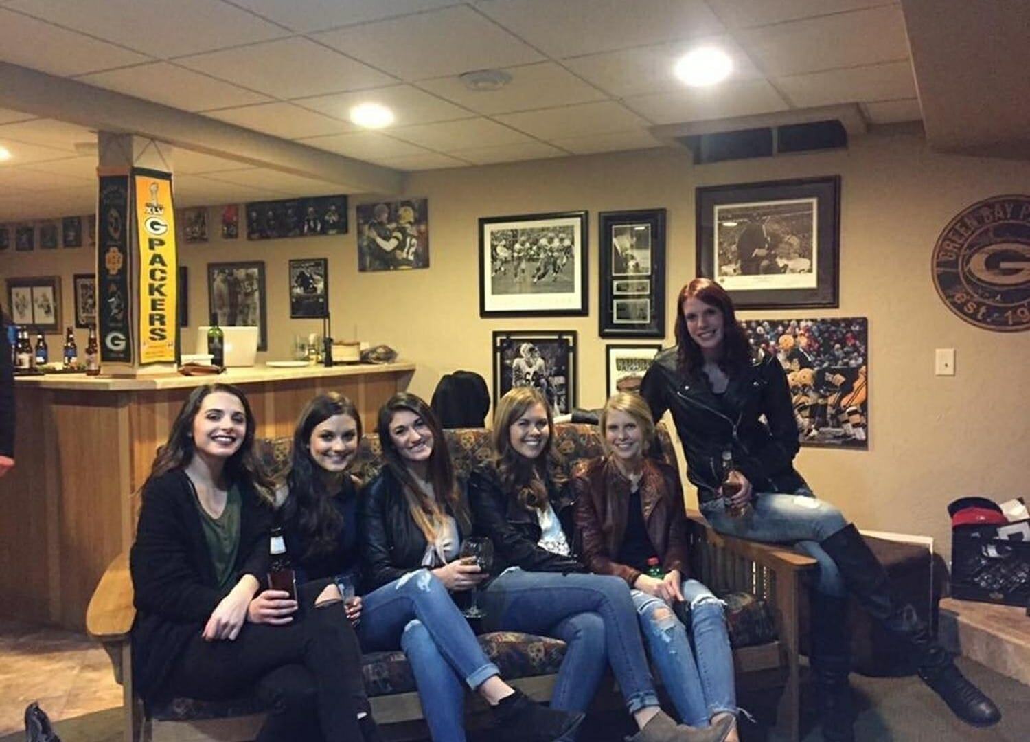 Can you spot what's so bizarre about this photo of a group of pals lounging on a sofa?