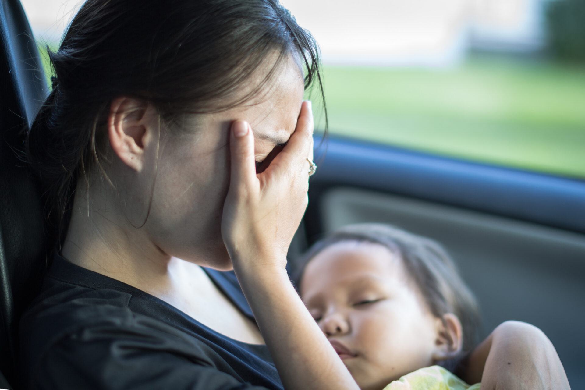 Stressed mom and baby in a car