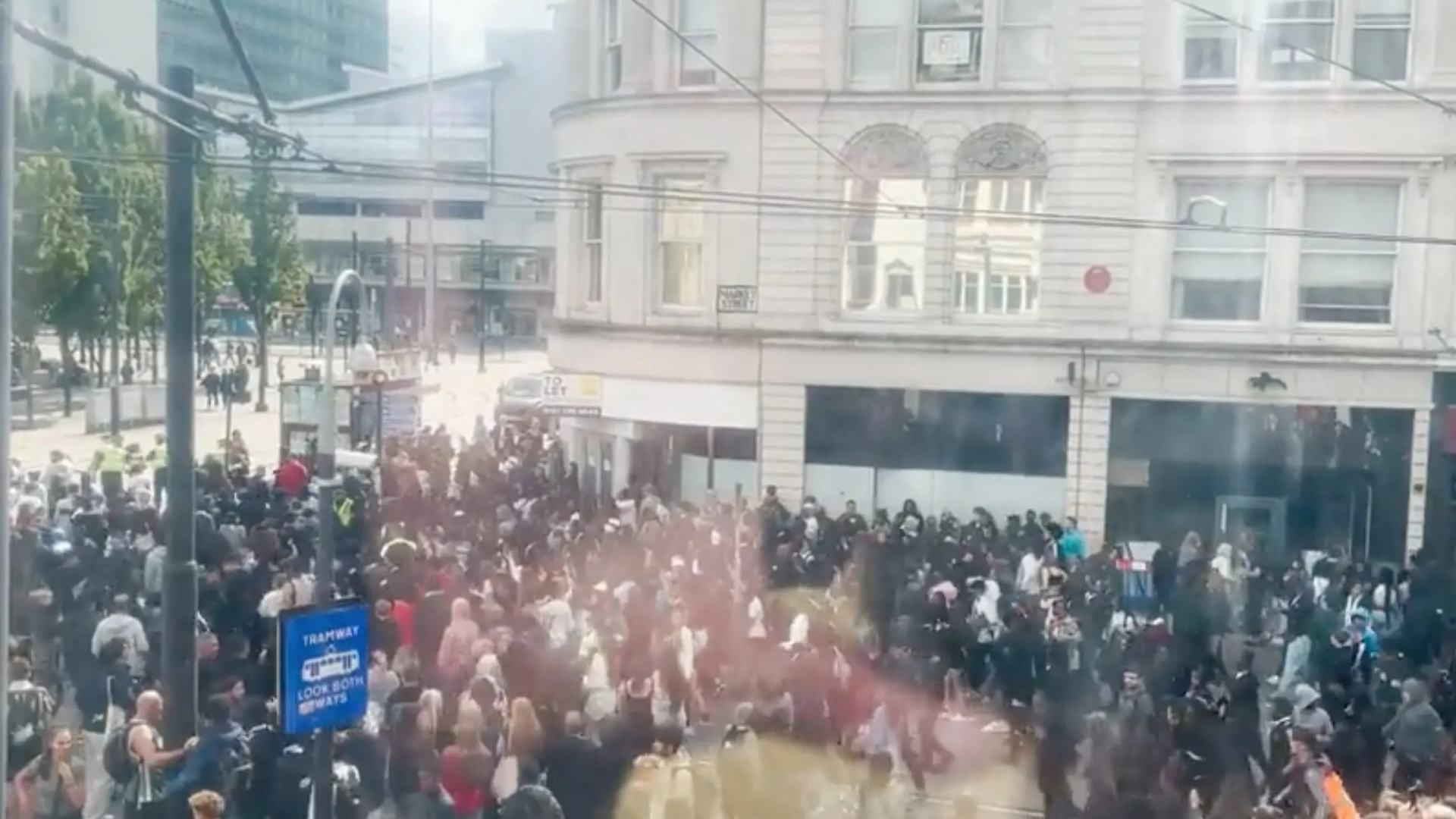 Shocking moment hundreds of school kids run riot in Manchester city centre as cops 'hit with eggs'