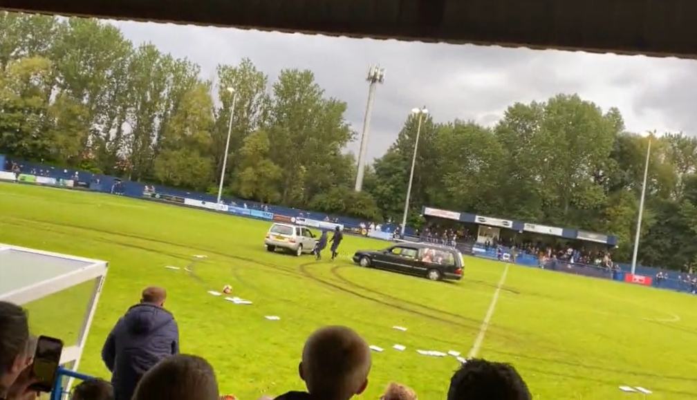 Watch as Gateshead vs Dunston football match descends into chaos when masked men in a HEARSE storm pitch